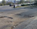 Ямы достаточно давно находятся в этом месте и крайне не приятны при выезде на основную дорогу. Из-за рельефа, их практически не видно.